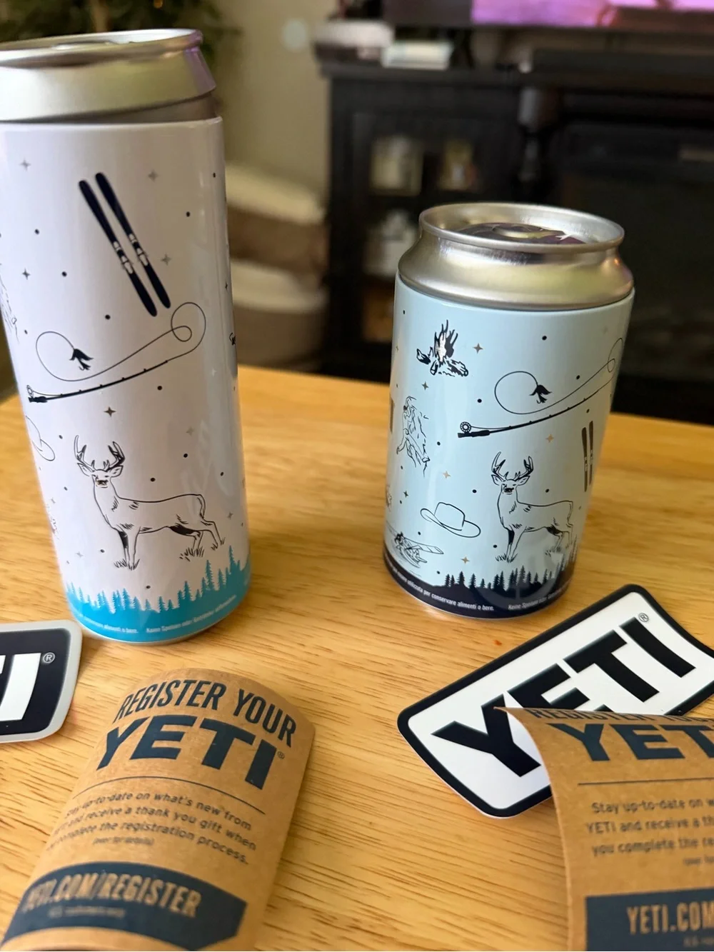 Yeti Slim Can Coolers in Light Gray with Blue Logo Accents